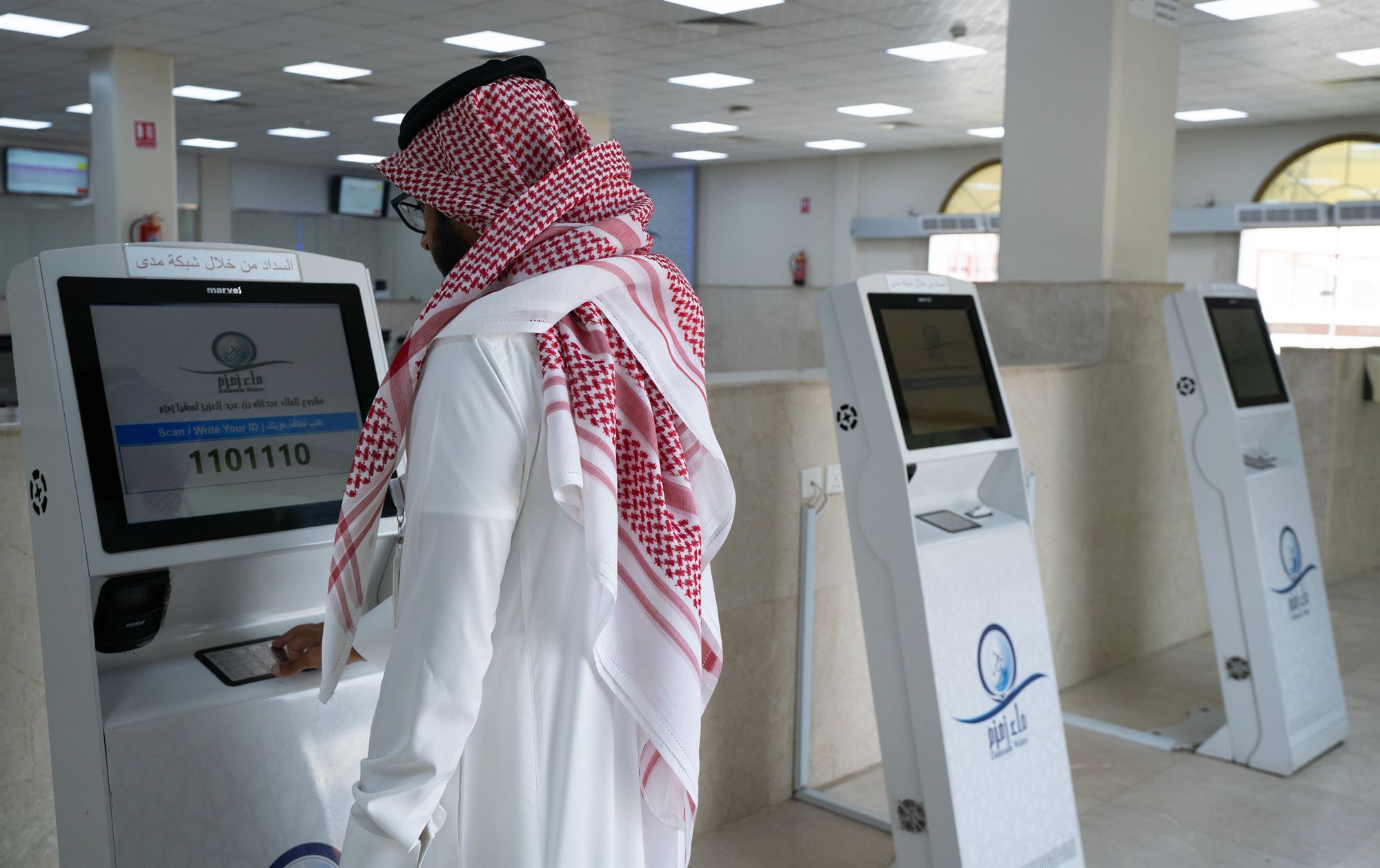 A visitor using a self-service kiosk at the King Abdullah Project for Zamzam Water in Makkah to process orders.